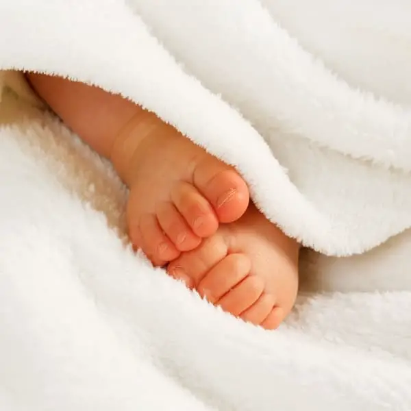 small feet in white blanket